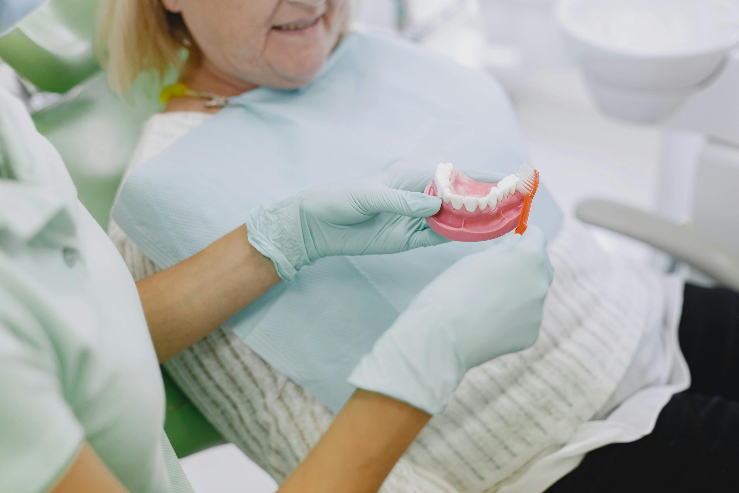 Woman talking to dentist about dentures